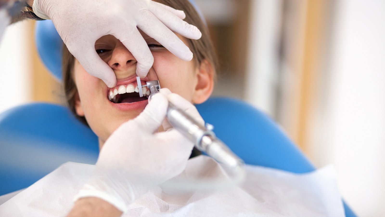 Professional dental cleaning being performed with portable equipment